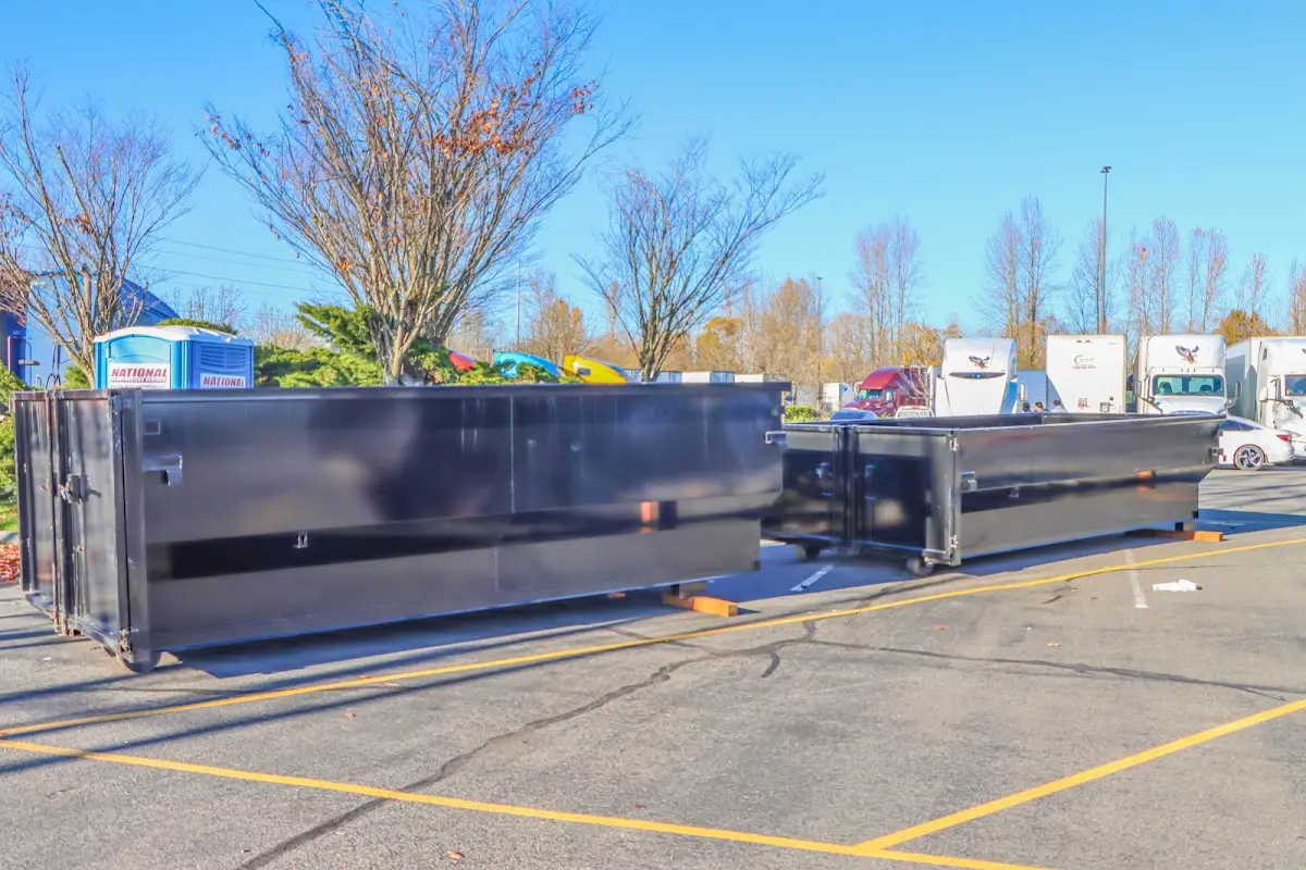 Professional dumpster rental service with roll-off container on residential driveway in Pleasant Prairie